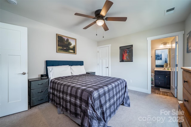 624 Cardwell Ln, Fletcher, NC 28732 - bedroom with light carpet, baseboards, ceiling fan, and connected bathroom