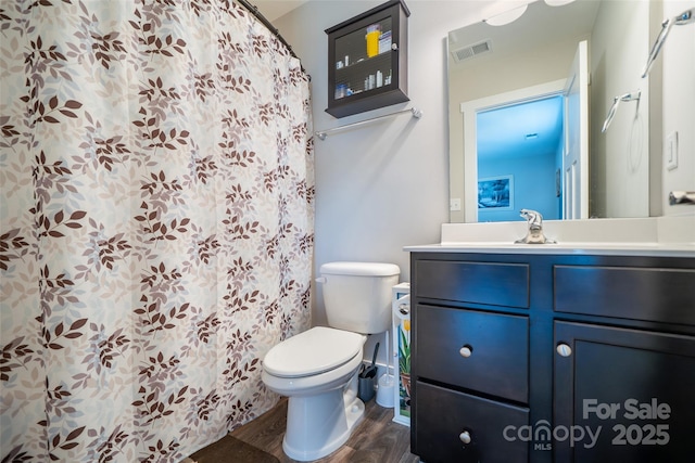 624 Cardwell Ln, Fletcher, NC 28732 - full bathroom with toilet, vanity, wood finished floors, and curtained shower