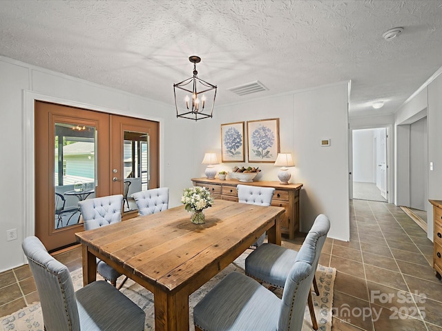 714 Helms Efird Rd, Marshville, NC 28103 - dining space featuring a chandelier, dark tile patterned flooring, french doors, and a textured ceiling