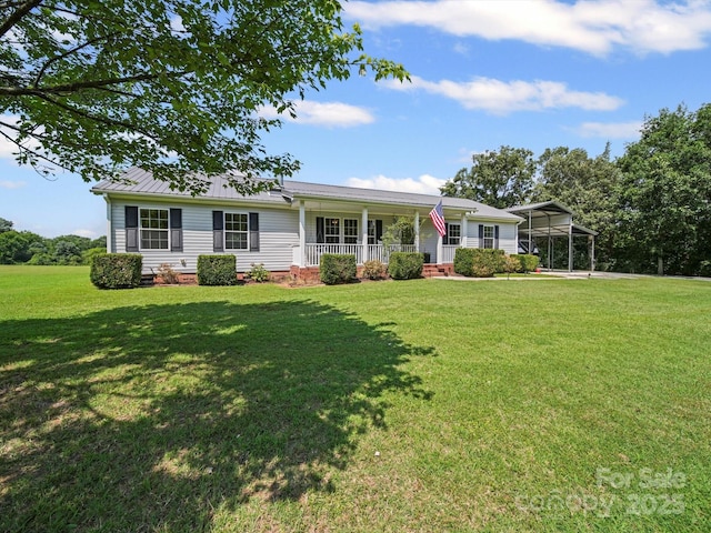 714 Helms Efird Rd, Marshville, NC 28103 - view of front of house featuring covered porch, a front yard, a carport, and a metal roof