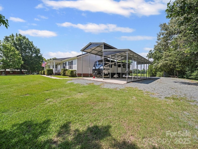 714 Helms Efird Rd, Marshville, NC 28103 - view of green lawn featuring a detached carport and gravel driveway