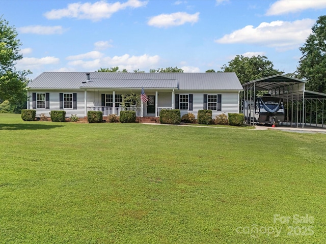 714 Helms Efird Rd, Marshville, NC 28103 - view of front of house with covered porch, a detached carport, a front yard, and a metal roof
