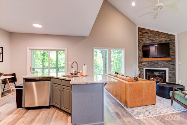 145 Inn At Crestwood Dr, Boone, NC 28607 - kitchen featuring stainless steel dishwasher, a sink, gray cabinets, open floor plan, and light stone countertops