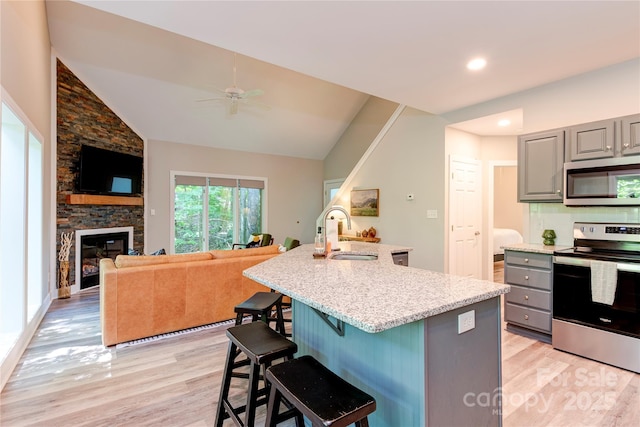 145 Inn At Crestwood Dr, Boone, NC 28607 - kitchen with appliances with stainless steel finishes, gray cabinetry, a sink, light wood-type flooring, and a ceiling fan