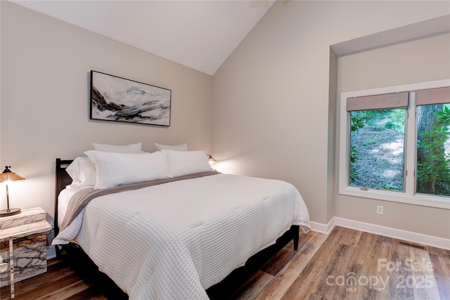 145 Inn At Crestwood Dr, Boone, NC 28607 - bedroom featuring wood finished floors, lofted ceiling, and baseboards