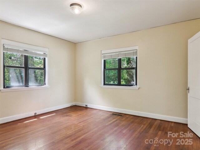 27 Alabama Ave, Weaverville, NC 28787 - unfurnished room with healthy amount of natural light, wood finished floors, and baseboards