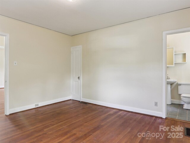 27 Alabama Ave, Weaverville, NC 28787 - unfurnished bedroom with wood finished floors, baseboards, and ensuite bathroom