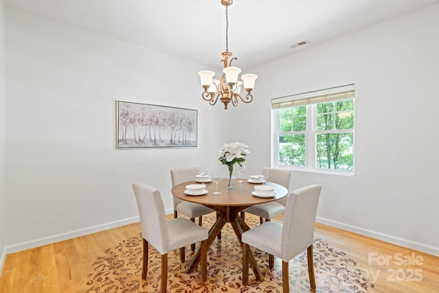 190 Jonathan Creek Dr, Etowah, NC 28729 - dining room with a chandelier, light wood-style floors, and baseboards