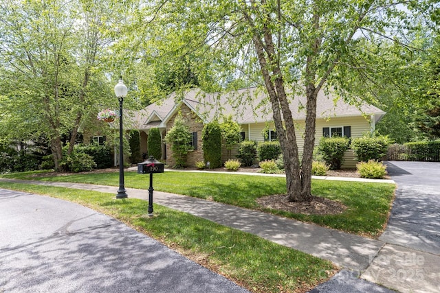 190 Jonathan Creek Dr, Etowah, NC 28729 - view of property hidden behind natural elements with a front yard