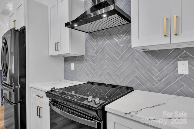 1246 Bob Falls Rd, Shelby, NC 28150 - kitchen featuring wall chimney exhaust hood, freestanding refrigerator, black / electric stove, tasteful backsplash, and white cabinetry