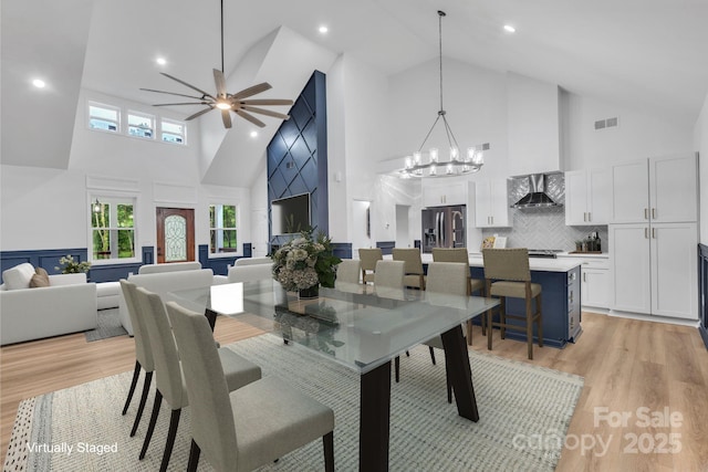 1246 Bob Falls Rd, Shelby, NC 28150 - dining area with high vaulted ceiling, light wood-type flooring, ceiling fan, and a chandelier