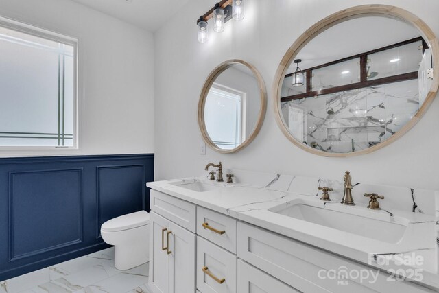 1246 Bob Falls Rd, Shelby, NC 28150 - full bath with marble finish floors, a marble finish shower, double vanity, wainscoting, and plenty of natural light