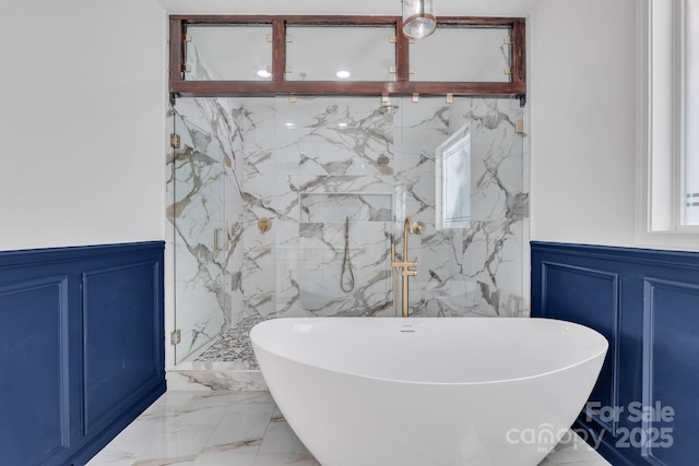 1246 Bob Falls Rd, Shelby, NC 28150 - bathroom with a decorative wall, marble tiled flooring, a wainscoted wall, a soaking tub, and a marble finish shower