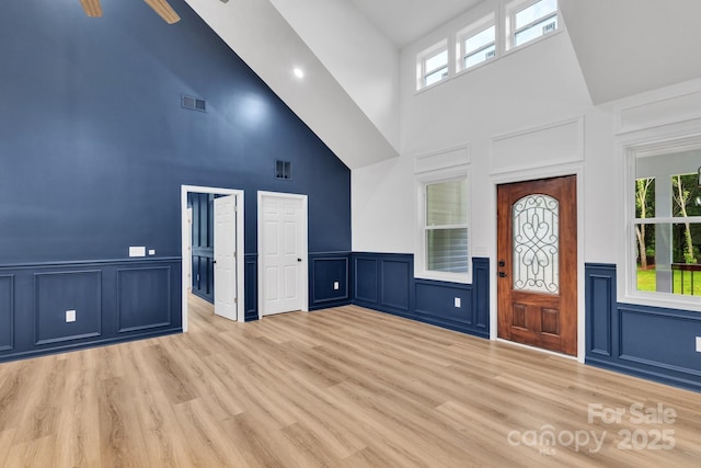 1246 Bob Falls Rd, Shelby, NC 28150 - entrance foyer with a towering ceiling, a decorative wall, light wood-style floors, plenty of natural light, and a wainscoted wall