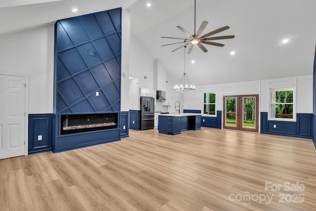 1246 Bob Falls Rd, Shelby, NC 28150 - unfurnished living room with high vaulted ceiling, a decorative wall, ceiling fan, light wood-type flooring, and a large fireplace