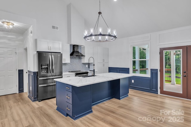 1246 Bob Falls Rd, Shelby, NC 28150 - kitchen featuring stainless steel appliances, high vaulted ceiling, wall chimney range hood, tasteful backsplash, and light stone countertops