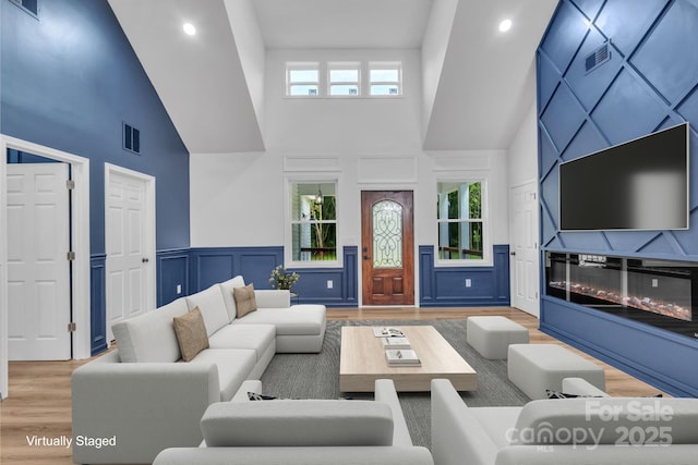 1246 Bob Falls Rd, Shelby, NC 28150 - living area with a towering ceiling, wood finished floors, a decorative wall, recessed lighting, and wainscoting