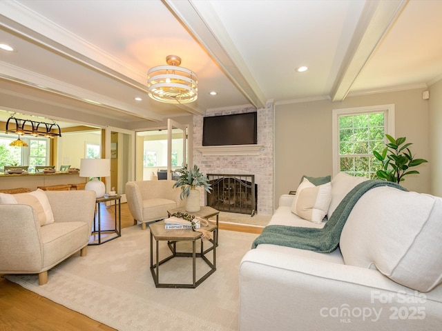7356 Terrace Dr, Charlotte, NC 28211 - living room featuring beamed ceiling, ornamental molding, plenty of natural light, a brick fireplace, and light wood-type flooring