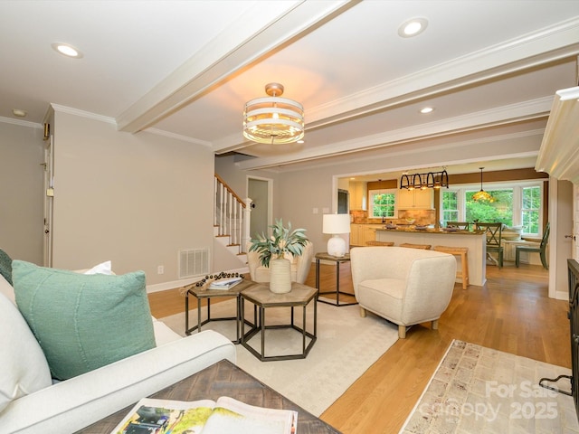 7356 Terrace Dr, Charlotte, NC 28211 - living area with stairs, ornamental molding, light wood-style floors, recessed lighting, and a chandelier