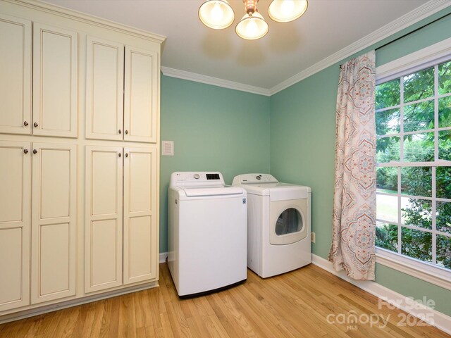 7356 Terrace Dr, Charlotte, NC 28211 - washroom featuring cabinet space, washer and clothes dryer, a chandelier, light wood finished floors, and crown molding