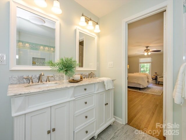 7356 Terrace Dr, Charlotte, NC 28211 - bathroom with double vanity, wood finished floors, ensuite bath, and ceiling fan