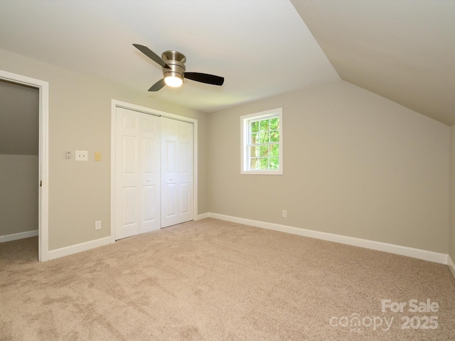 7356 Terrace Dr, Charlotte, NC 28211 - unfurnished bedroom featuring carpet floors, vaulted ceiling, a closet, a ceiling fan, and baseboards