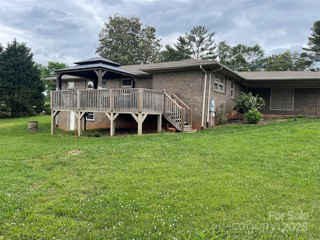 114 Aqua Dr, Forest City, NC 28043 - back of house with a wooden deck, a yard, and brick siding