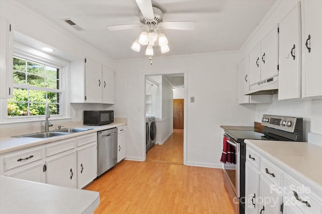 103 Hampshire Ln, Canton, NC 28716 - kitchen with appliances with stainless steel finishes, under cabinet range hood, a sink, washer / clothes dryer, and light countertops