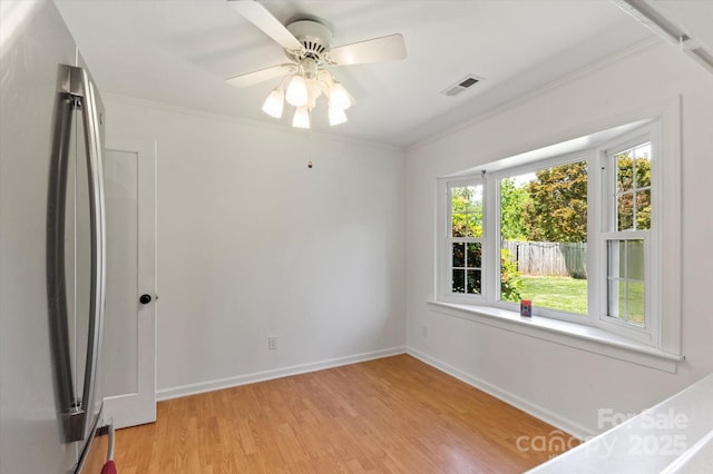103 Hampshire Ln, Canton, NC 28716 - unfurnished bedroom featuring freestanding refrigerator, light wood finished floors, baseboards, crown molding, and a ceiling fan