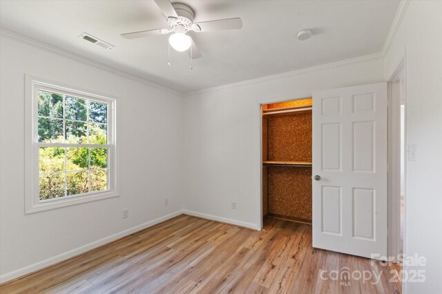 103 Hampshire Ln, Canton, NC 28716 - unfurnished bedroom featuring ornamental molding, light wood-type flooring, a spacious closet, baseboards, and a closet