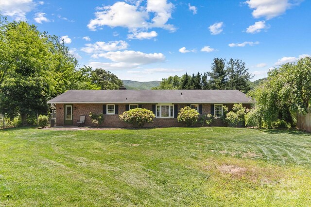 103 Hampshire Ln, Canton, NC 28716 - ranch-style home featuring brick siding, a front yard, and a chimney