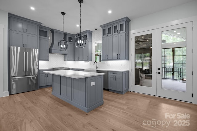 2577 Bonnybrook Cir, Rock Hill, SC 29732 - kitchen with stainless steel appliances, gray cabinetry, custom range hood, light countertops, and recessed lighting