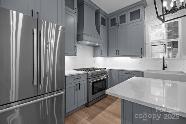 2577 Bonnybrook Cir, Rock Hill, SC 29732 - kitchen with stainless steel appliances, custom range hood, a sink, gray cabinets, and backsplash
