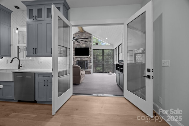 2577 Bonnybrook Cir, Rock Hill, SC 29732 - kitchen featuring stainless steel dishwasher, gray cabinets, light wood-type flooring, ceiling fan, and a sink