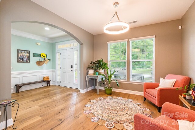 85017 Newloch Ct, Lancaster, SC 29720 - entryway featuring arched walkways, light wood-style floors, crown molding, and a wainscoted wall