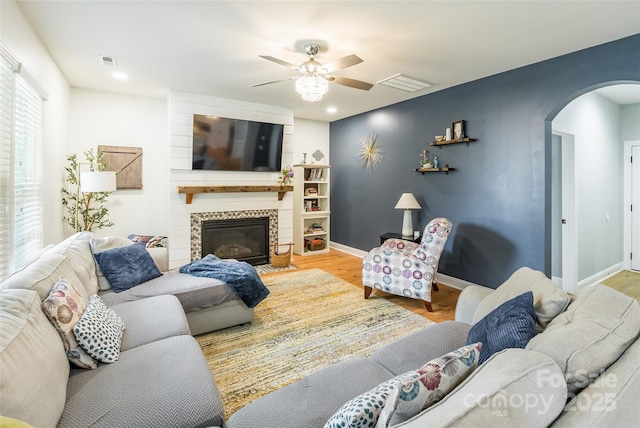 85017 Newloch Ct, Lancaster, SC 29720 - living room featuring arched walkways, wood finished floors, ceiling fan, baseboards, and a fireplace