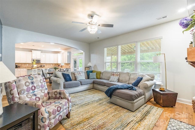 85017 Newloch Ct, Lancaster, SC 29720 - living room with light wood-style flooring, arched walkways, a ceiling fan, and baseboards