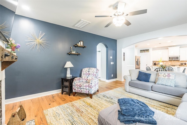 85017 Newloch Ct, Lancaster, SC 29720 - living room featuring arched walkways, ceiling fan, light wood-type flooring, and baseboards
