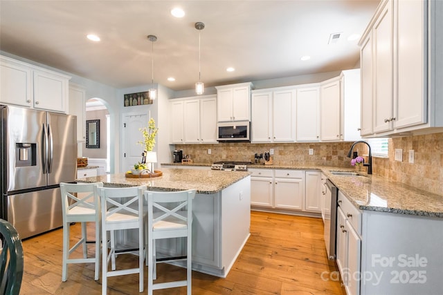 85017 Newloch Ct, Lancaster, SC 29720 - kitchen with stainless steel appliances, a sink, arched walkways, backsplash, and recessed lighting