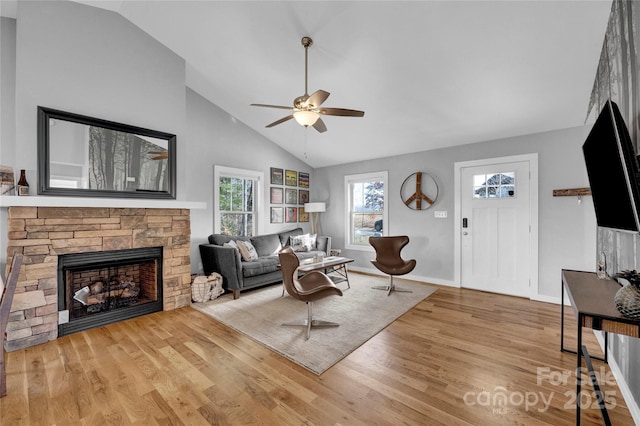 11 Ridge Brook Dr, Weaverville, NC 28787 - living room featuring a ceiling fan, wood finished floors, a stone fireplace, baseboards, and high vaulted ceiling