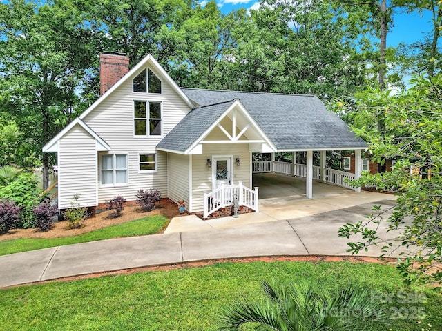 2248 White Heron Rd, Liberty Hill, SC 29074 - view of front facade with driveway, a chimney, roof with shingles, and an attached carport