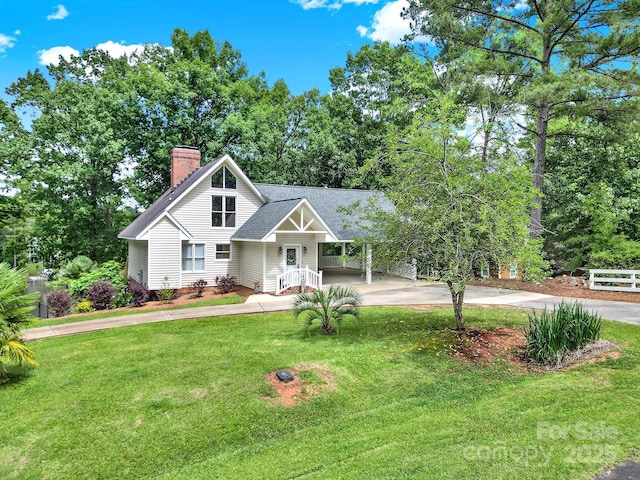 2248 White Heron Rd, Liberty Hill, SC 29074 - view of front of home with driveway, a chimney, a front yard, an attached carport, and a shingled roof