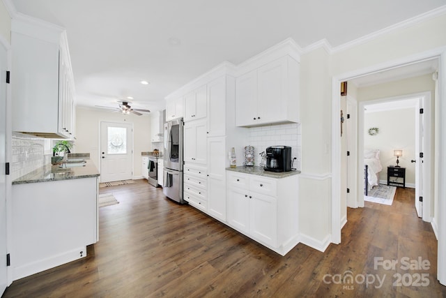 2248 White Heron Rd, Liberty Hill, SC 29074 - kitchen with stainless steel appliances, recessed lighting, decorative backsplash, white cabinets, and dark wood-style flooring