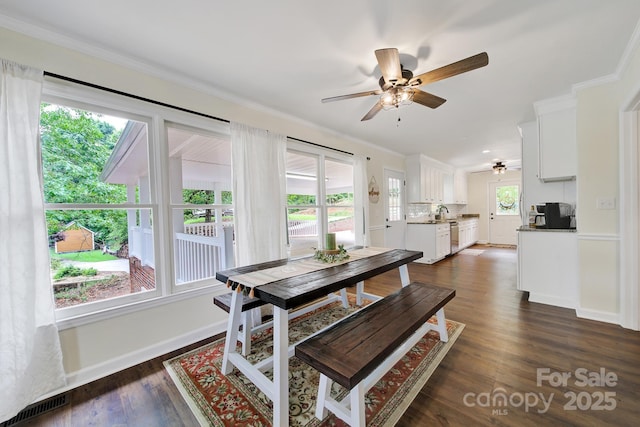 2248 White Heron Rd, Liberty Hill, SC 29074 - dining area with a ceiling fan, ornamental molding, dark wood-style flooring, and baseboards
