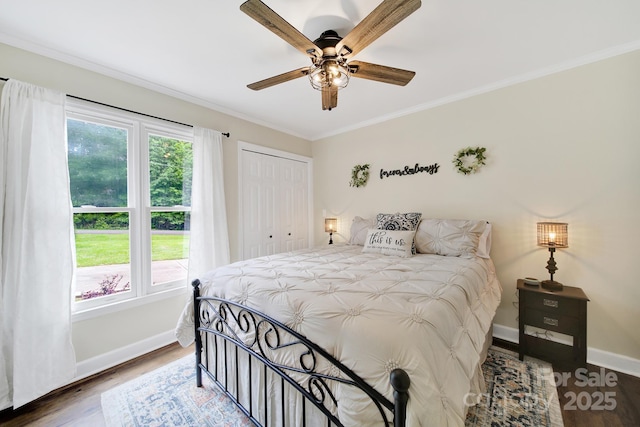 2248 White Heron Rd, Liberty Hill, SC 29074 - bedroom with wood finished floors, baseboards, crown molding, a closet, and ceiling fan