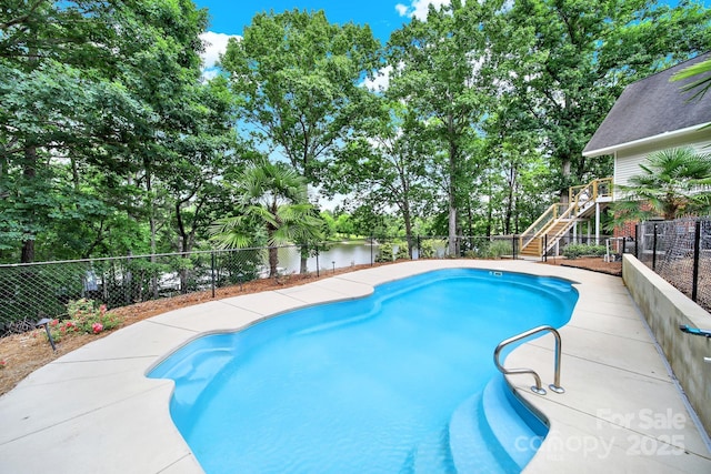 2248 White Heron Rd, Liberty Hill, SC 29074 - view of pool featuring a fenced backyard, stairs, view of wooded area, and a water view