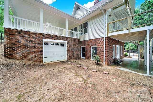 2248 White Heron Rd, Liberty Hill, SC 29074 - view of side of home featuring brick siding, dirt driveway, and a garage