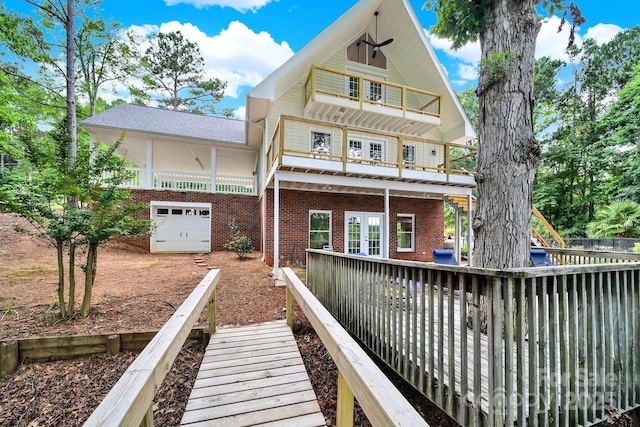 2248 White Heron Rd, Liberty Hill, SC 29074 - back of property with brick siding, an attached garage, dirt driveway, and french doors