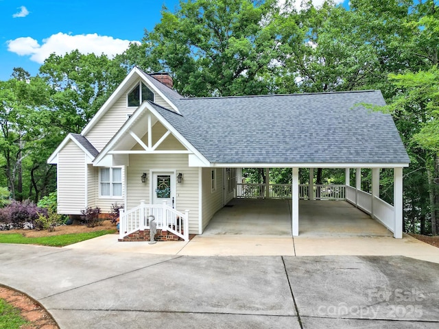 2248 White Heron Rd, Liberty Hill, SC 29074 - view of front of home with a shingled roof, driveway, a chimney, and a carport