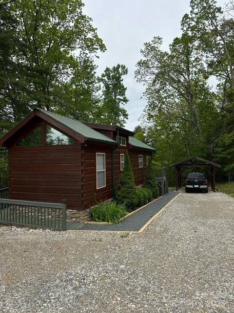 623 Overlook Dr, Spruce Pine, NC 28777 - view of home's exterior featuring a carport, driveway, and log exterior